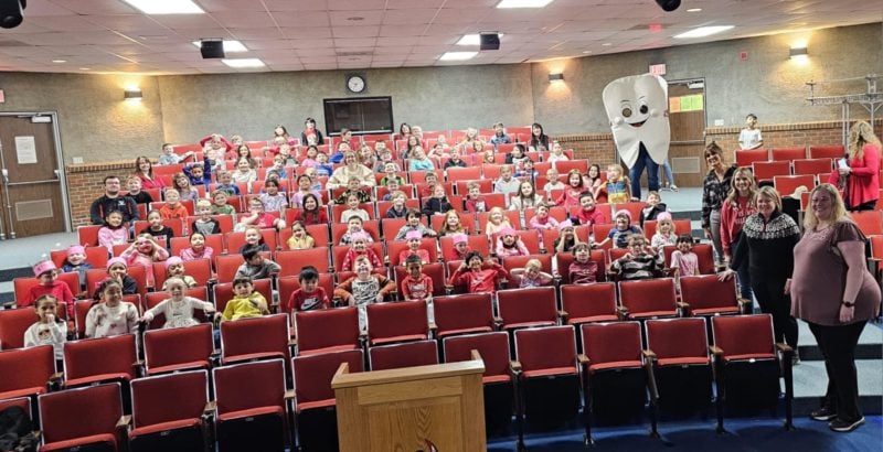 Auditorium of school kids learning about dental best practices